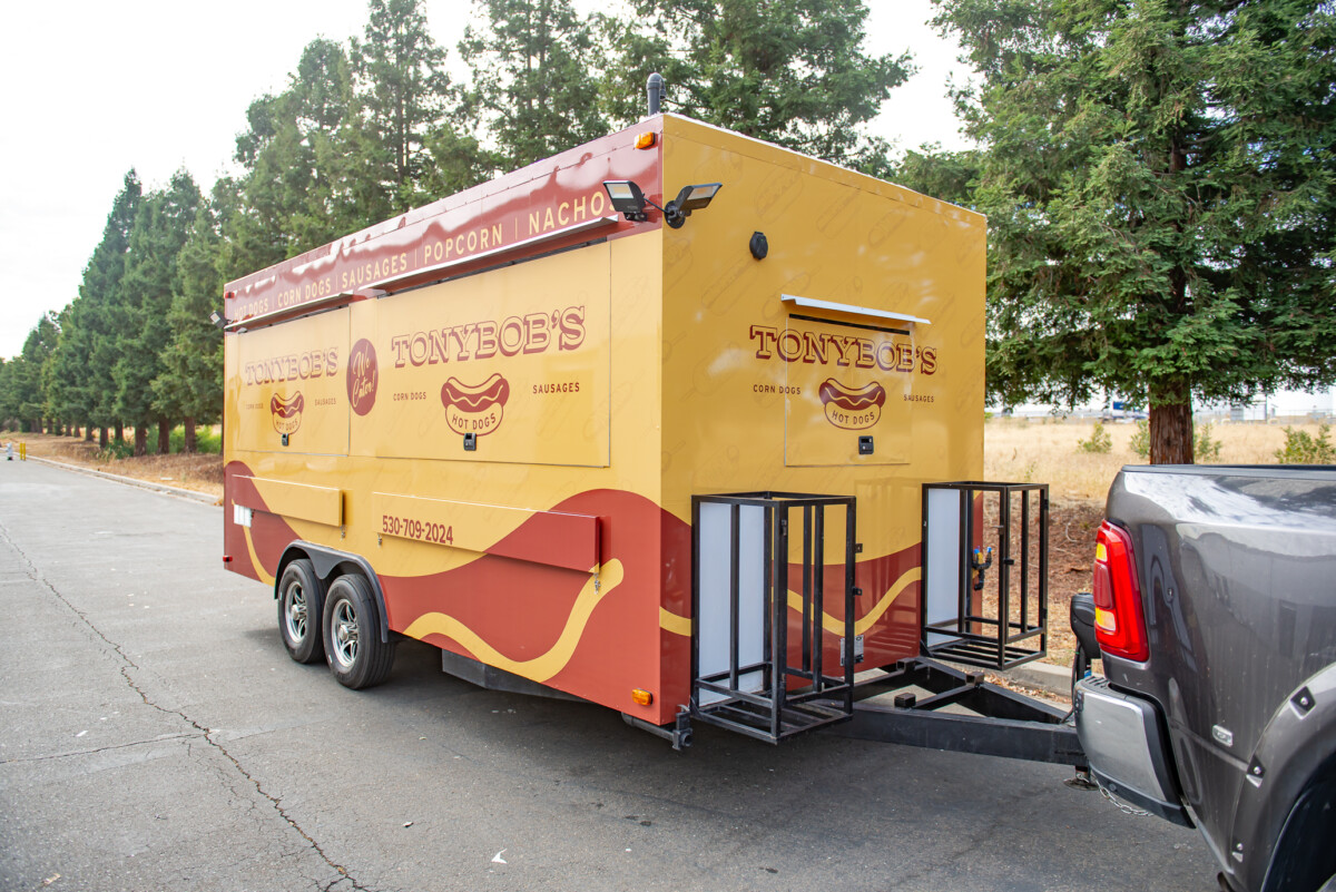 Tony Bob's Hotdogs food truck in mustard yellow and sausage-brown brand colors.